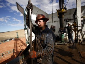 His overalls caked in mud, roughneck Brian Waldner wrestles with pipe as North Dakota's new horizon unfolds around him.